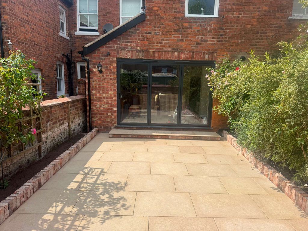 Modern porcelain patio with decorative borders and planting areas