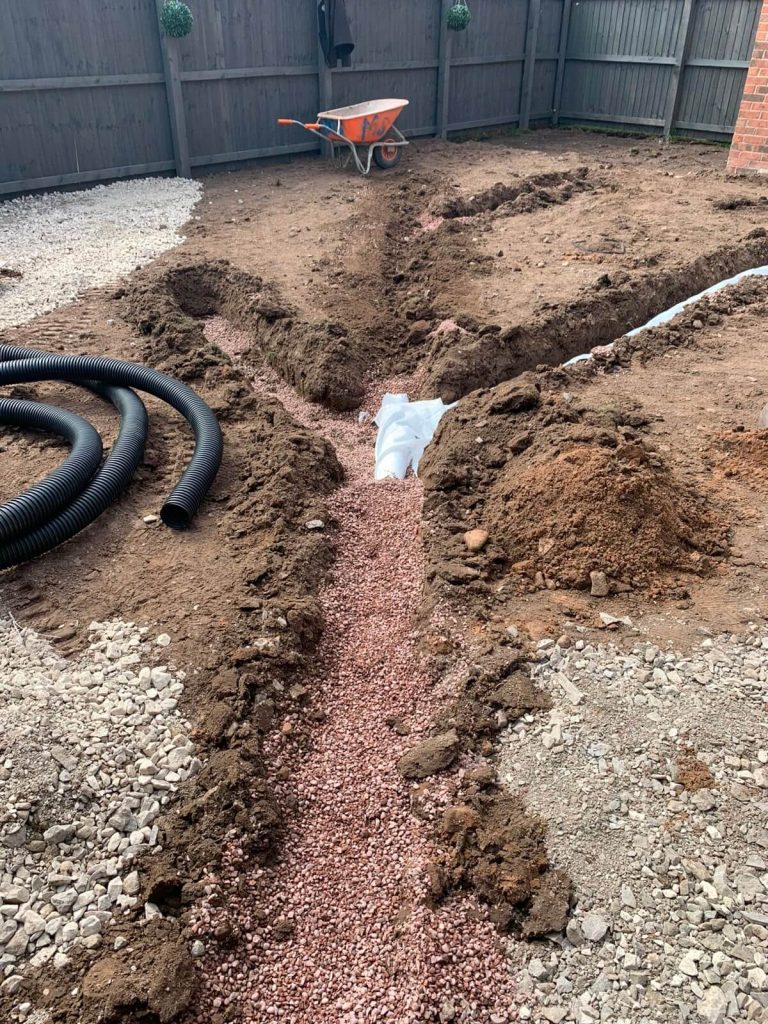 Groundworks and drainage preparation during landscaping project