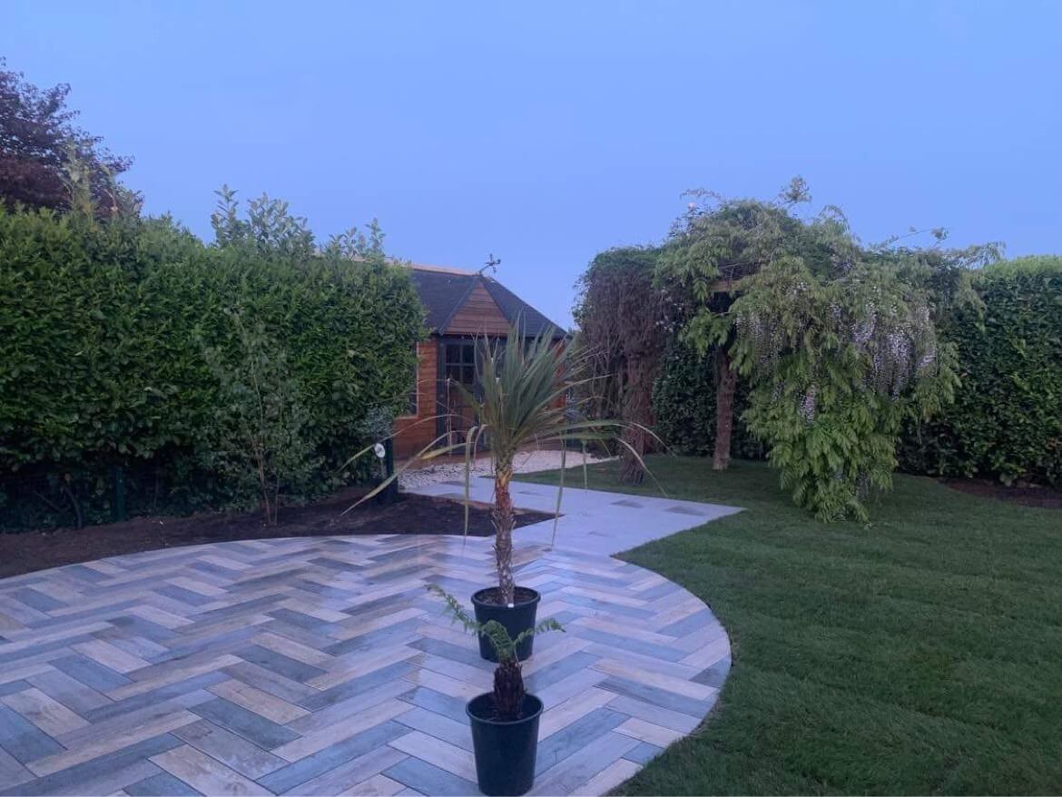Contemporary garden redesign featuring premium paving and landscaped borders